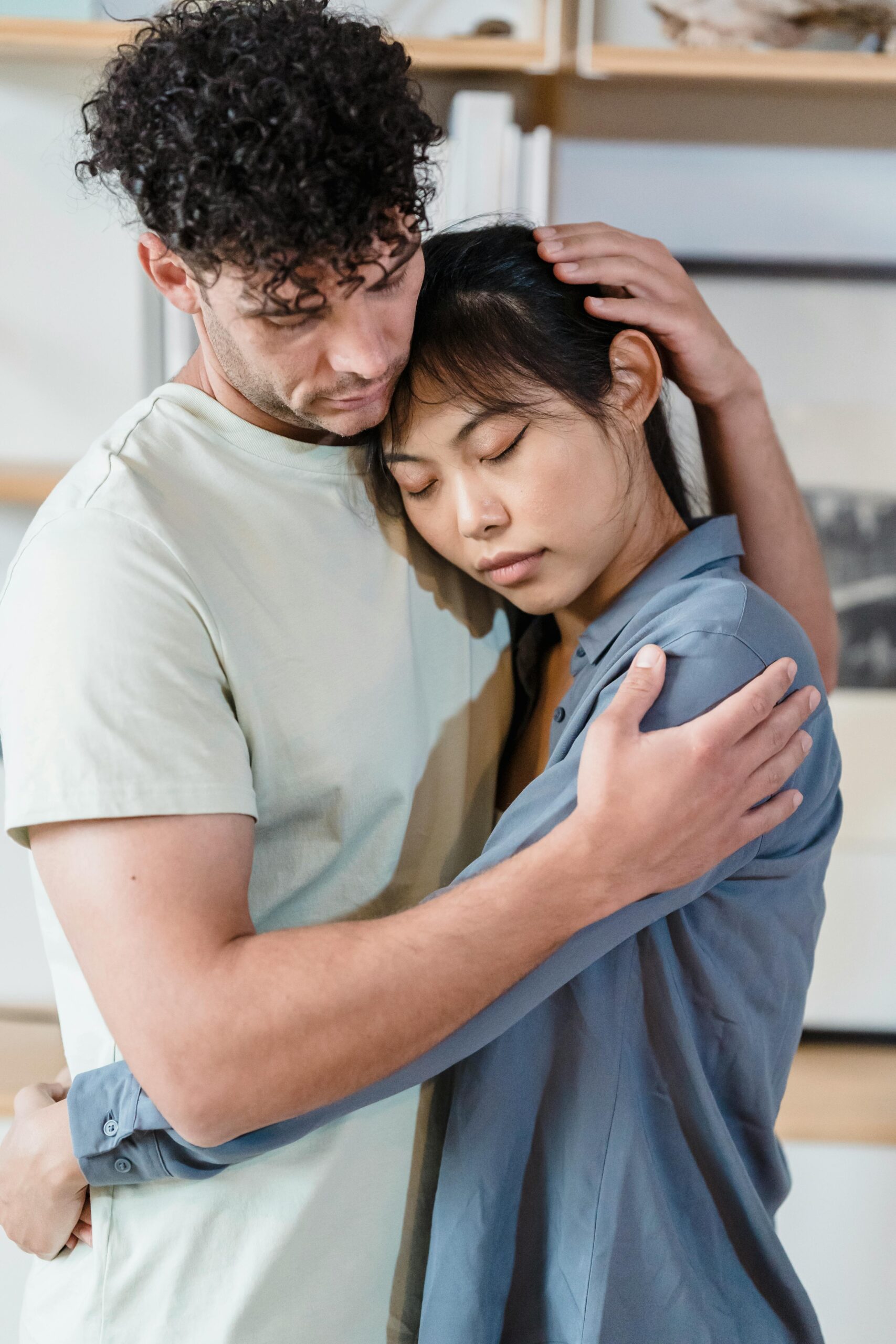 Tender moment between a couple embracing, highlighting love and support.